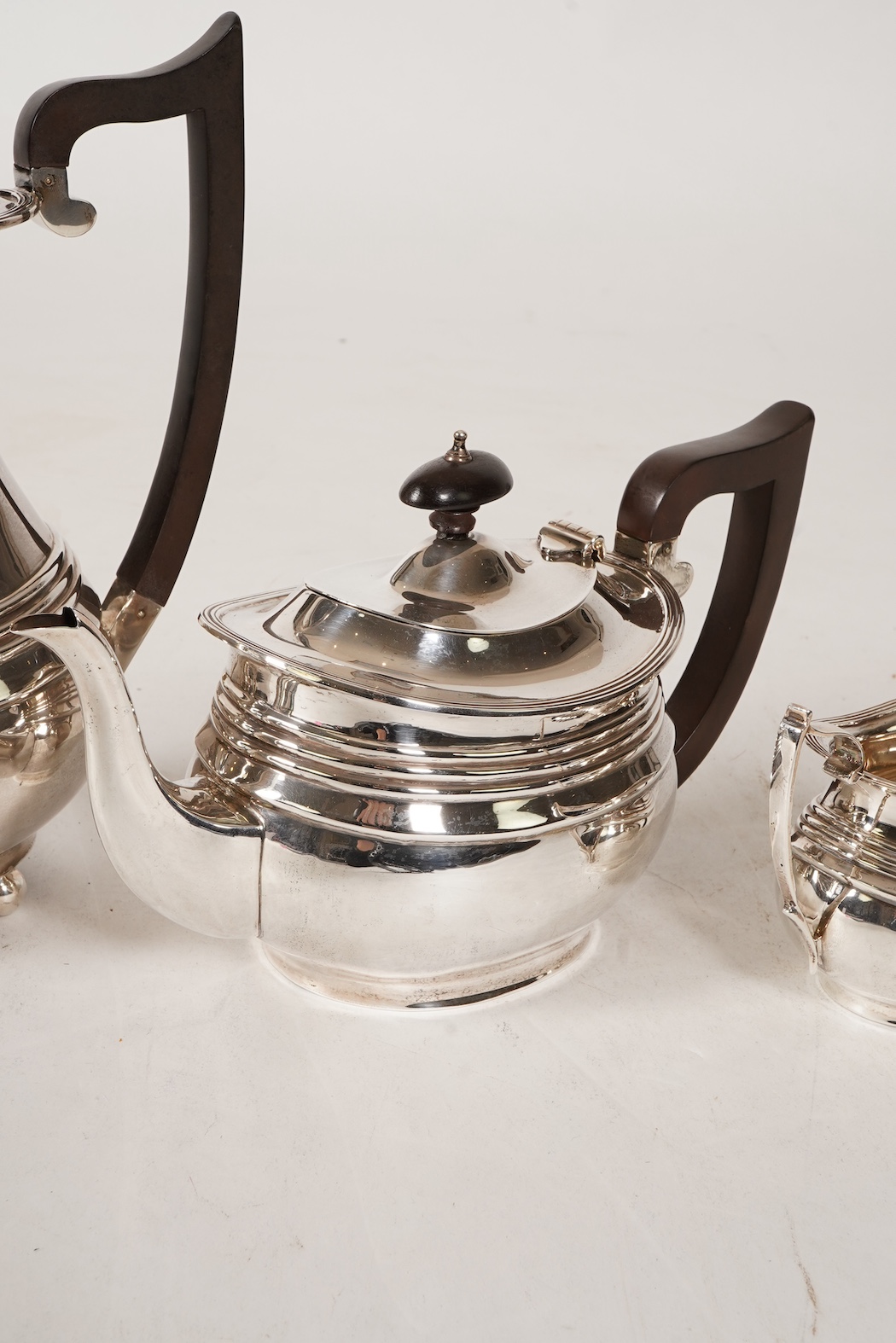 A George V four piece silver tea set, comprising teapot, hot water pot, sugar bowl and milk jug, by S. Blanckensee & Son Ltd